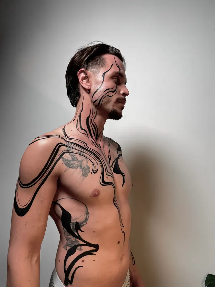 Flowing black body painting on a male model