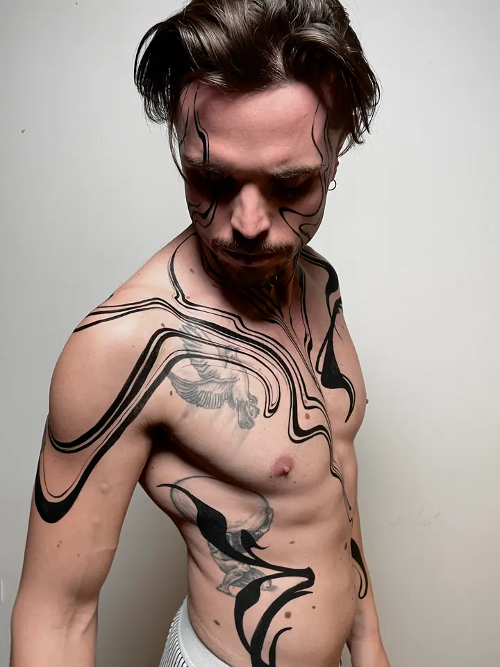 Flowing black body painting on a male model