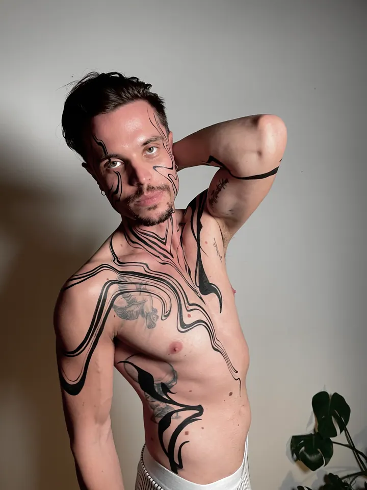 Flowing black body painting on a male model