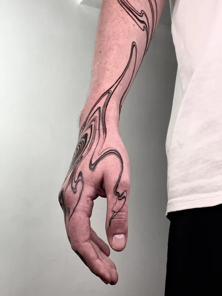 Flowing abstract tattoo on the forearm and hand