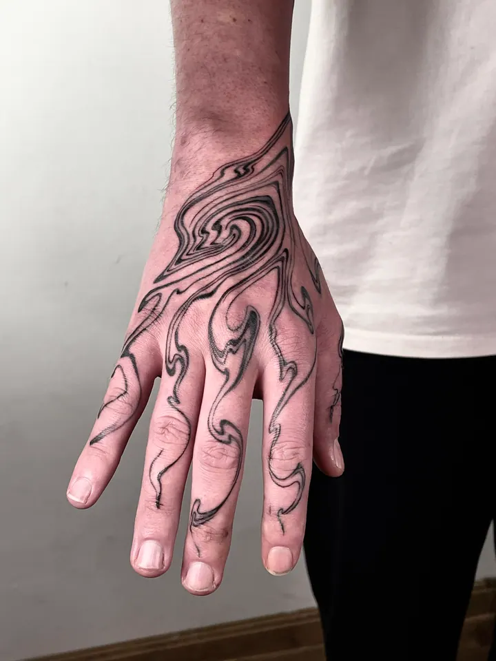 Flowing abstract tattoo on the forearm and hand