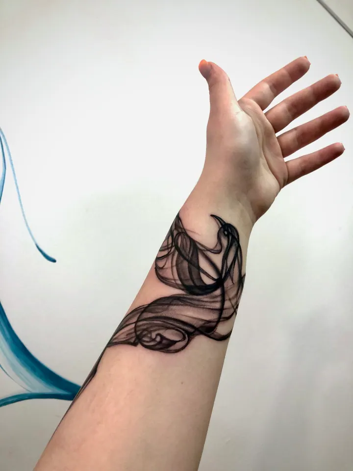 Abstract tattoos with flowing lines on the forearm