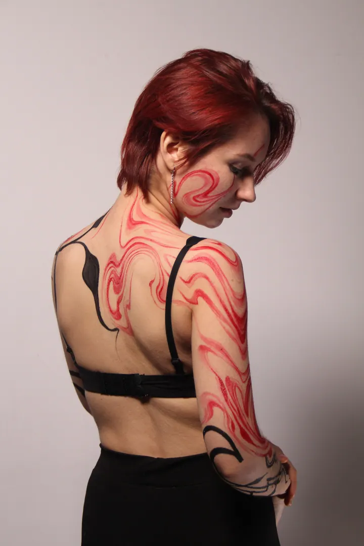 Flowing red and black body painting