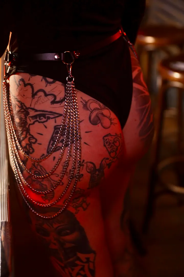 Leather straps and chains around the hips