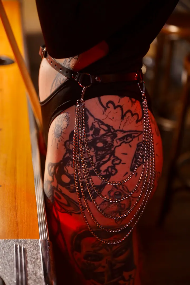 Leather straps and chains around the hips