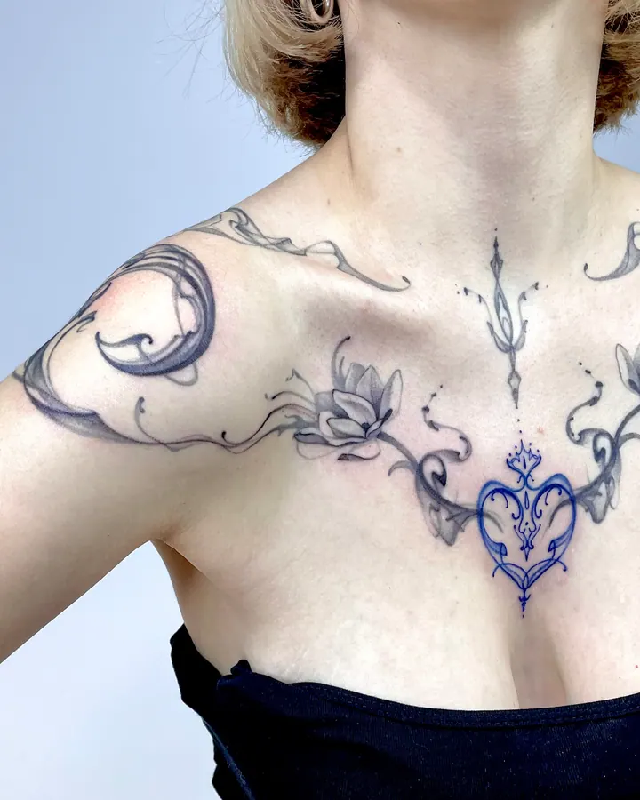 Floral chest tattoo with a blue heart design stencil