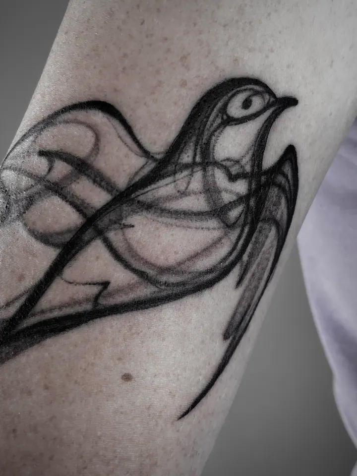Bird tattoo with flowing abstract lines on the arm