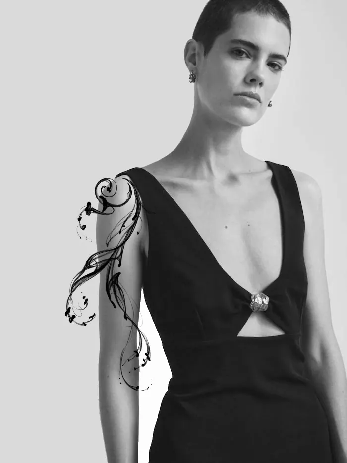 Flowing ornamental tattoo design shown on the arm
