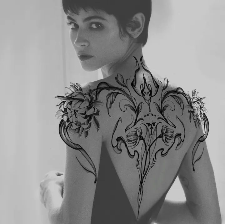 Floral and ornamental tattoo composition shown across the back
