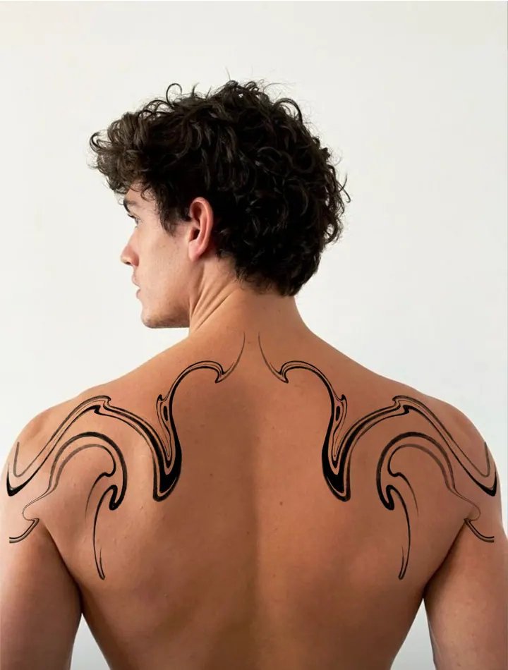 Symmetrical flowing tattoo design shown on the shoulders and upper back
