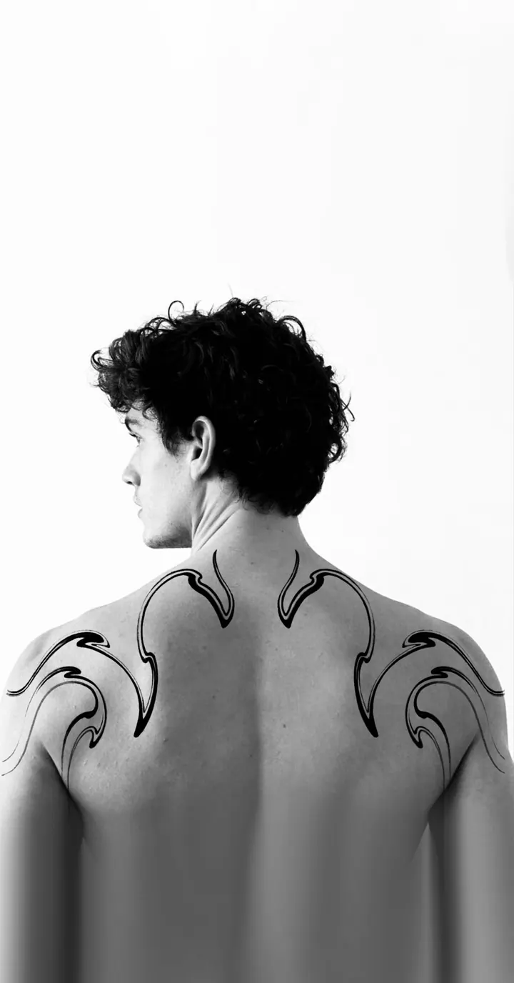 Symmetrical flowing tattoo design shown on the shoulders and upper back